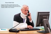 Man in arm sling and neck brace sitting at desk on the phone